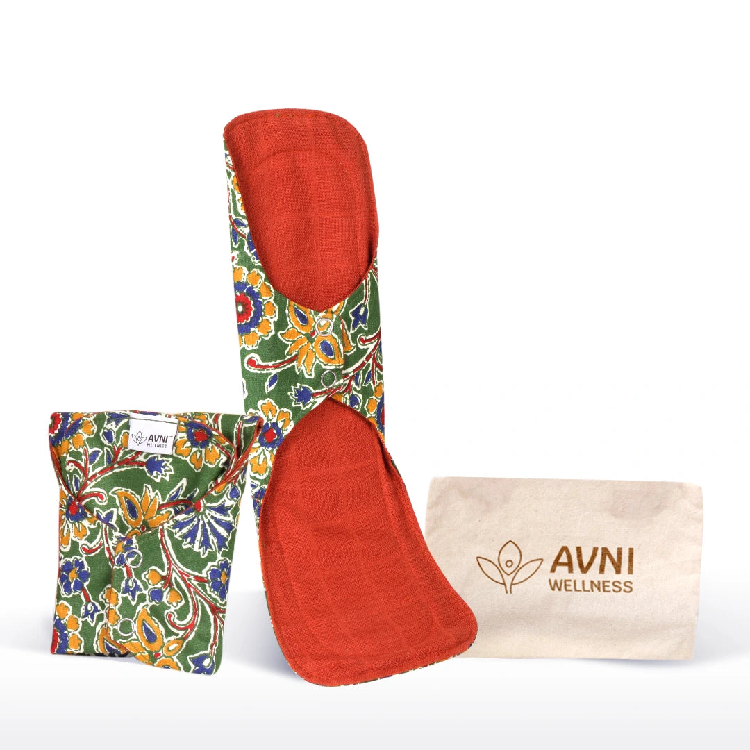 Red and floral-patterned reusable sanitary pads with pouch and beige bag labeled 'AVNI Wellness' on a white background.